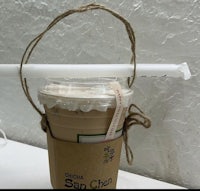 a cup of coffee with a straw attached to it